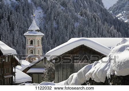 Snow-capped village with mountain forest in the background View Large Photo Image Stock Image - Snow-capped village with mountain forest in the background. Fotosearch