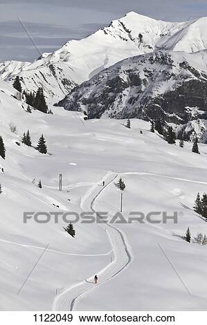 Stock Photo - Snow path and mountain range in background. Fotosearch