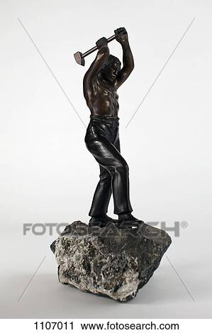 Statue of a manual worker swinging a sledgehammer View Large Photo Image Stock Image - Statue of a manual worker swinging a sledgehammer. Fotosearch