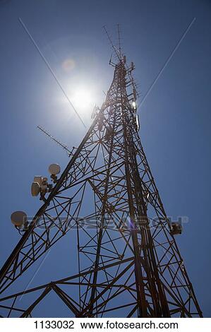 Stock Image - Sun shining down on a communications tower. Fotosearch