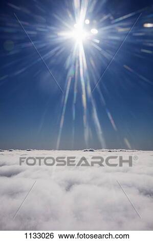 The sun shining on a cloudscape View Large Photo Image Stock Photograph - The sun shining on a cloudscape. Fotosearch