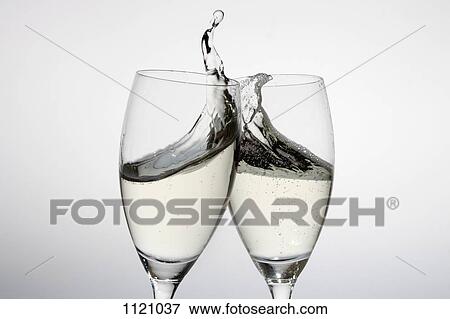 Toasting with two glasses of champagne View Large Photo Image Stock Photo - Toasting with two glasses of champagne. Fotosearch