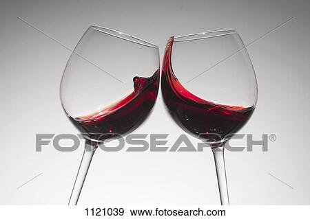 Stock Photo - Toasting with two glasses of red wine. Fotosearch