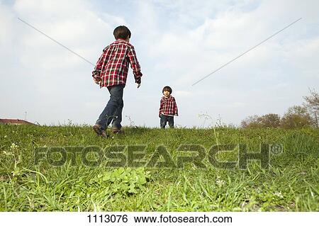 Two brothers in matching outfits outdoors View Large Photo Image Stock Photograph - Two brothers in matching outfits outdoors. Fotosearch