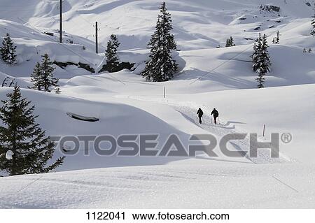Two hikers on a snow laden path View Large Photo Image Stock Image - Two hikers on a snow laden path. Fotosearch