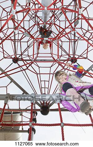 Two kids looking down from jungle gym View Large Photo Image Stock Photography - Two kids looking down from jungle gym. Fotosearch