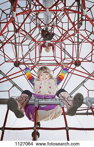 Two kids on jungle gym looking down View Large Photo Image Picture - Two kids on jungle gym looking down. Fotosearch