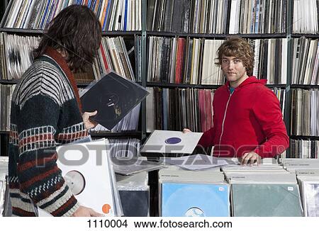 Two men shopping in a record store View Large Photo Image Picture - Two men shopping in a record store. Fotosearch