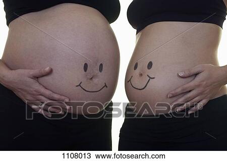 Two pregnant women with smiley faces on their bellies, midsection View Large Photo Image Stock Image - Two pregnant women with smiley faces on their bellies, midsection. Fotosearch