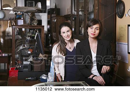 Two woman in an antiques shop View Large Photo Image Stock Image - Two woman in an antiques shop. Fotosearch