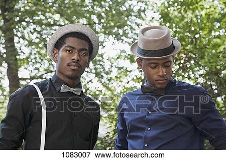 Two young black men dressed in bow ties and hats View Large Photo Image Stock Photo - Two young black men dressed in bow ties and hats. Fotosearch