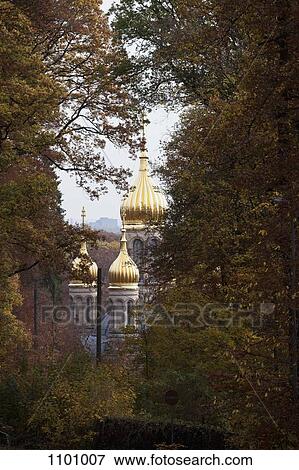 Stock Photo - View through trees of the Russian Orthodox Church of Saint Elizabeth, Wiesbaden, Germany. Fotosearch