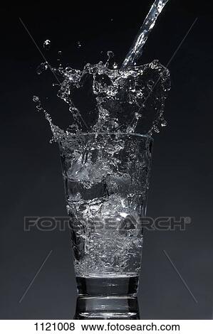 Water being poured into a glass View Large Photo Image Stock Photo - Water being poured into a glass. Fotosearch