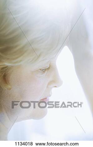 Stock Photo - Woman looking down. Fotosearch