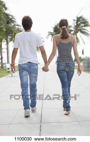 Young couple have s stroll hand in hand View Large Photo Image Stock Image - Young couple have s stroll hand in hand. Fotosearch