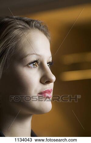Stock Image - Young woman staring. Fotosearch