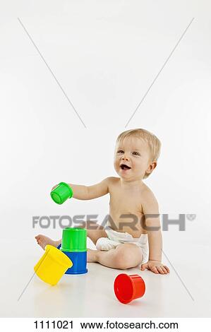 A baby boy playing with plastic cups View Large Photo Image Stock Image - A baby boy playing with plastic cups. Fotosearch