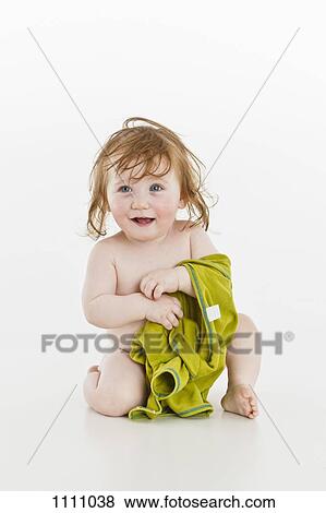 A baby girl holding an item of clothing View Large Photo Image Stock Photo - A baby girl holding an item of clothing. Fotosearch