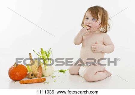 A baby girl next to vegetables View Large Photo Image Stock Photograph - A baby girl next to vegetables. Fotosearch