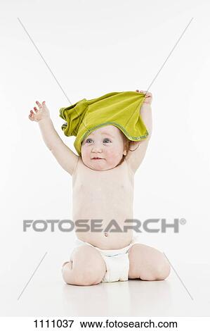 A baby girl pulling her shirt off View Large Photo Image Stock Photo - A baby girl pulling her shirt off. Fotosearch
