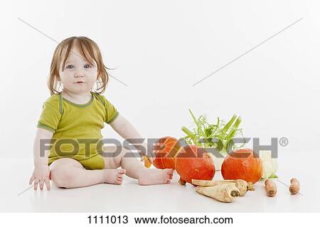 A baby girl sitting with vegetables View Large Photo Image Stock Image - A baby girl sitting with vegetables. Fotosearch