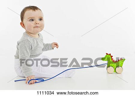 A baby girl with a toy View Large Photo Image Picture - A baby girl with a toy. Fotosearch