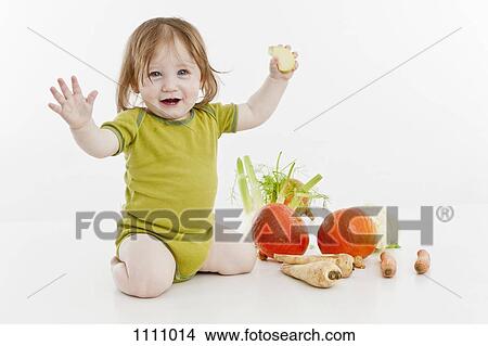 A baby girl with vegetables View Large Photo Image Picture - A baby girl with vegetables. Fotosearch