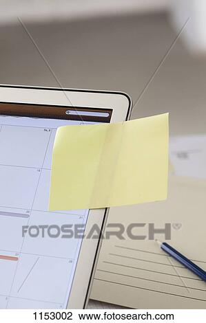 A blank adhesive note stuck to a laptop screen with a calendar View Large Photo Image Stock Image - A blank adhesive note stuck to a laptop screen with a calendar. Fotosearch
