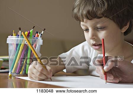 A boy and a friend drawing with colored pencils, viewpoint of boy View Large Photo Image Stock Photo - A boy and a friend drawing with colored pencils, viewpoint of boy. Fotosearch