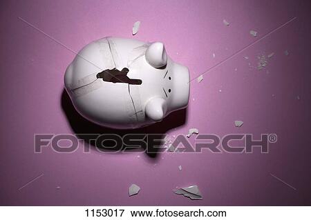 Stock Photo - A broken piggy bank with pieces taped back together. Fotosearch