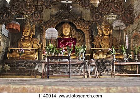 Picture - A Buddhist shrine with three golden Buddhas, Inle Lake, Burma. Fotosearch