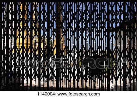 Picture - A Buddhist temple viewed from behind metal shutters, Inle Lake, Burma. Fotosearch