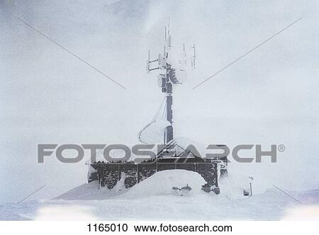 A building with a large antenna covered in snow View Large Photo Image Stock Image - A building with a large antenna covered in snow. Fotosearch