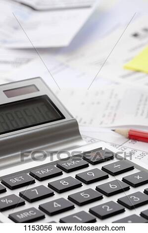 A calculator on top of a mess of financial paperwork View Large Photo Image Stock Photograph - A calculator on top of a mess of financial paperwork . Fotosearch