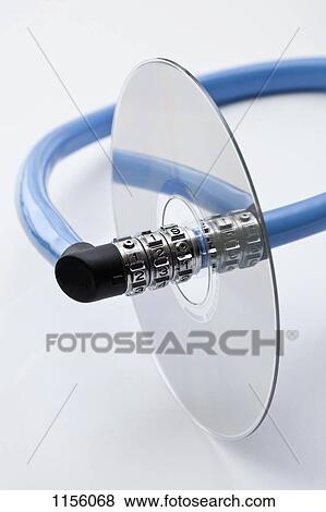 Stock Photo - A combination bicycle lock threading through a compact disc. Fotosearch