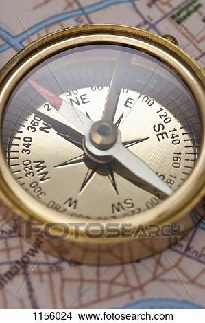 A compass on top of a road map, focus on compass View Large Photo Image Picture - A compass on top of a road map, focus on compass. Fotosearch