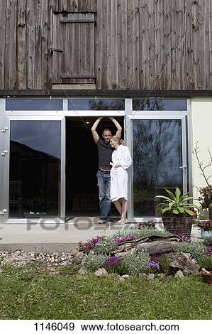 A couple leaning against the doorway of their house in the morning View Large Photo Image Stock Photo - A couple leaning against the doorway of their house in the morning. Fotosearch