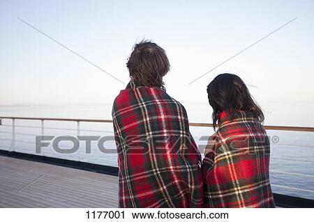 A couple on a ship deck, wrapped in blankets, looking at view, Seattle, Washington, USA View Large Photo Image Stock Image - A couple on a ship deck, wrapped in blankets, looking at view, Seattle, Washington, USA. Fotosearch
