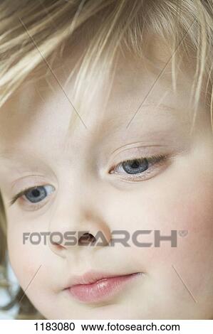A cute little girl looking down, extreme close-up View Large Photo Image Stock Image - A cute little girl looking down, extreme close-up. Fotosearch