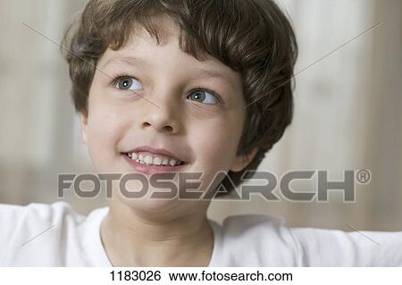 A cute, smiling young boy looking up and to the side View Large Photo Image Stock Photograph - A cute, smiling young boy looking up and to the side. Fotosearch