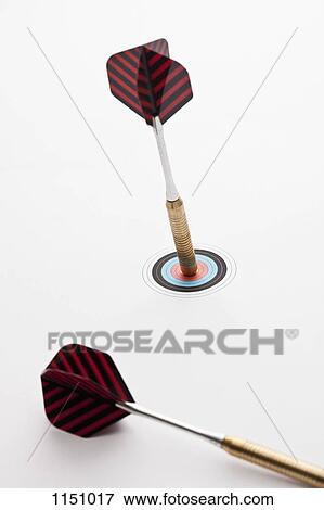 A dart stuck in the bull's eye of a miniature archery target View Large Photo Image Stock Photo - A dart stuck in the bull's eye of a miniature archery target. Fotosearch