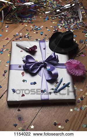 A gift surround by confetti and party decorations View Large Photo Image Stock Image - A gift surround by confetti and party decorations. Fotosearch