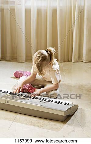 A girl playing an electronic keyboard View Large Photo Image Stock Photo - A girl playing an electronic keyboard. Fotosearch