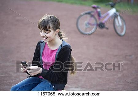 A girl text messaging View Large Photo Image Stock Photo - A girl text messaging. Fotosearch