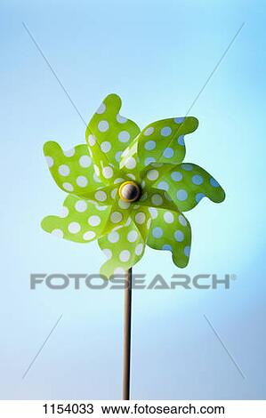 Stock Image - A green pinwheel with polka dots. Fotosearch