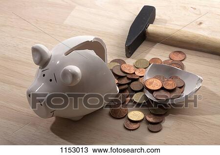 A hammer lying next to a broken piggy bank with Euro coins spilling out View Large Photo Image Stock Image - A hammer lying next to a broken piggy bank with Euro coins spilling out. Fotosearch