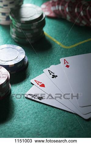 A hand of cards displaying four aces, gambling chips in background View Large Photo Image Stock Image - A hand of cards displaying four aces, gambling chips in background. Fotosearch