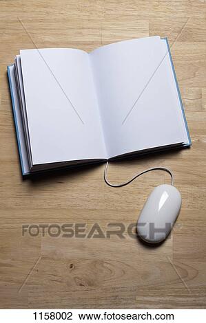 A hardcover book with a computer mouse attached to it View Large Photo Image Stock Image - A hardcover book with a computer mouse attached to it. Fotosearch