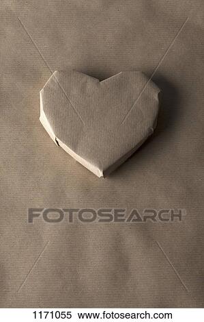 A heart shaped object wrapped in brown paper View Large Photo Image Stock Photography - A heart shaped object wrapped in brown paper. Fotosearch