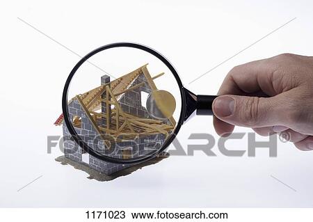A human hand holding a magnifying glass up to a partially constructed miniature house model View Large Photo Image Stock Image - A human hand holding a magnifying glass up to a partially constructed miniature house model. Fotosearch